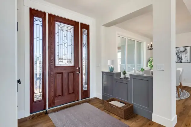 Foyer of Dewinton custom home adjacent to dining room with custom cabinetry