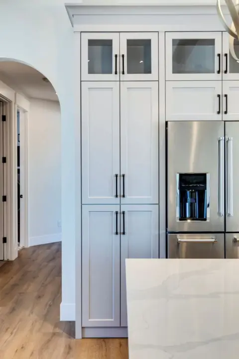 Kitchen pantry doors leading to walk-in butler's pantry