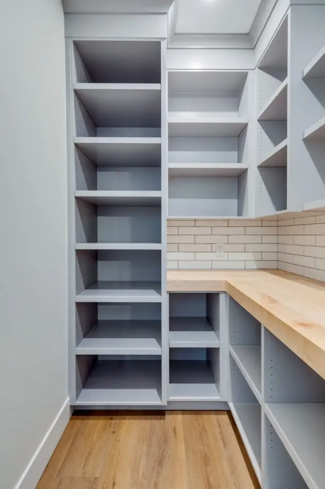 Custom shelving and butcher block counter in butler's pantry