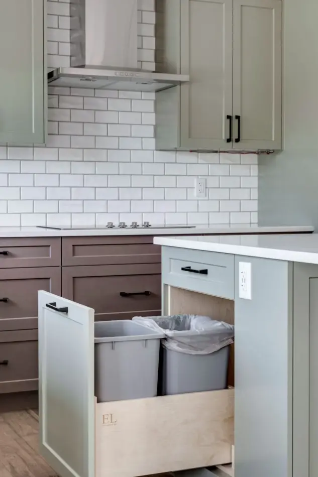Closeup of pullout garbage and recycling center in custom Calgary kitchen