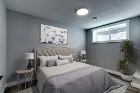 Bedroom in Calgary basement suite with large window to let in light.