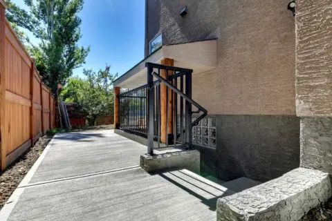 New separate covered entranceto legal basement suite in Calgary with glass block window for privacy and extra light.