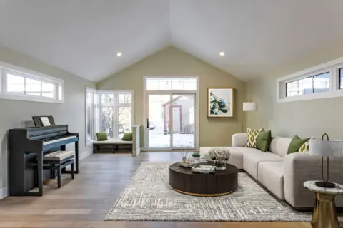 Rear addition lined with large windows and vaulted ceiling