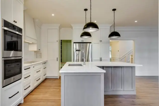 Side view L-shaped kitchen island with view into mudroom
