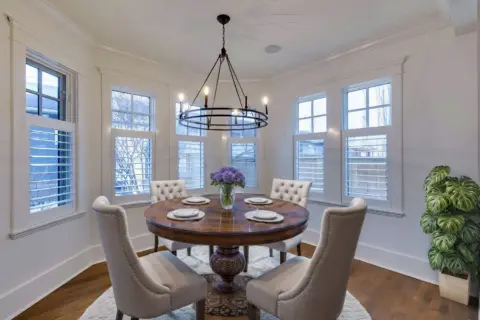 Light-filled dining alcove with striking black light fixture