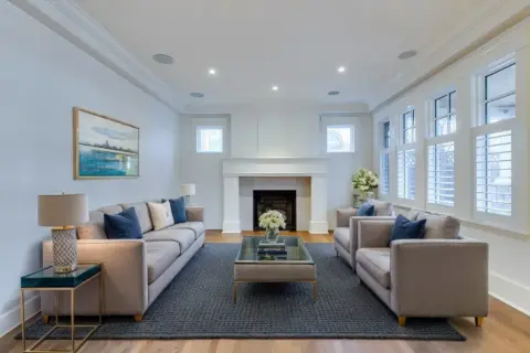 Living room featuring custom gas fireplace surround