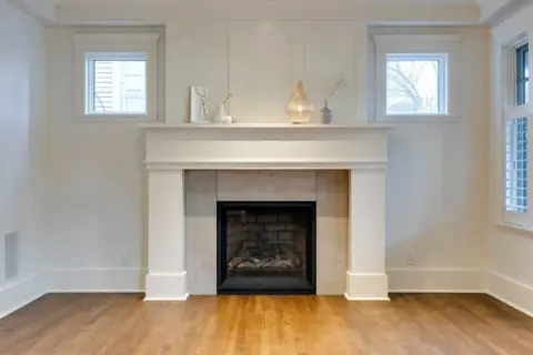 Close up of custom millwork gas fireplace surround