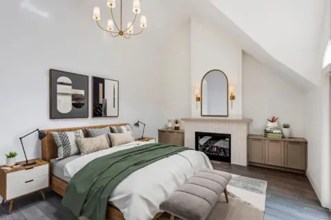 Vaulted ceiling bedroom with gas fireplace and custom built-in cabinetry