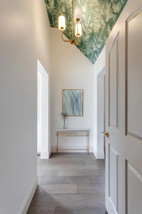 Vaulted hallway leading to third-floor Calgary townhome suite