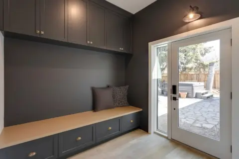 Mudroom with dark dramatic custom cabinetry in remodeled Wildwood Calgary home, which included front and rear additions