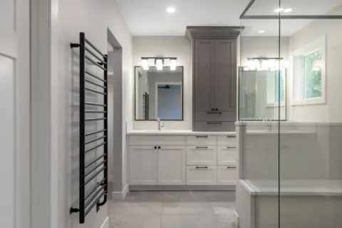 Spa-inspired ensuite in fully renovated Cranston home featuring a double vanity and updated fixtures