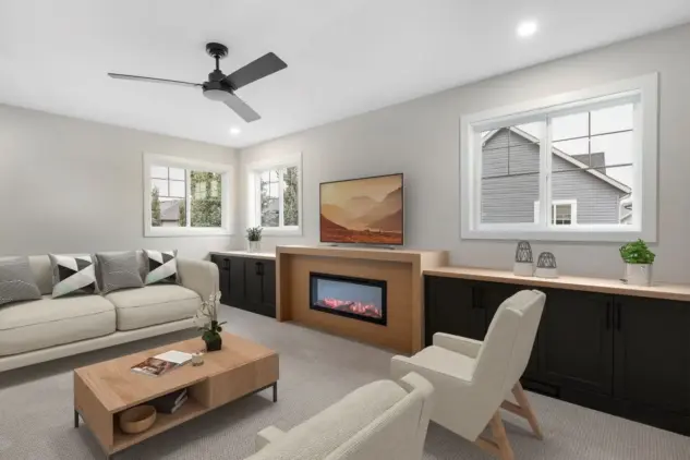 Striking fireplace surround flanked by millwork cabinetry in family room of Cranston home fully renovated by Melanson Homes