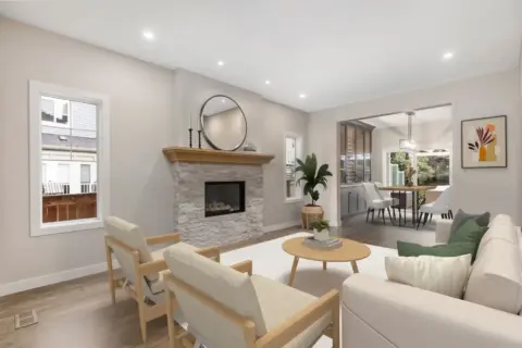 Living room and dining room in fully renovated Cranston home featuring reimagined stone fireplace, custom wine cabinet, updated flooring, modern lighting, and neutral finishes