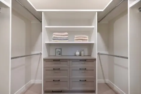 Spacious walk-in closet with custom built-ins in fully renovated Cranston Home