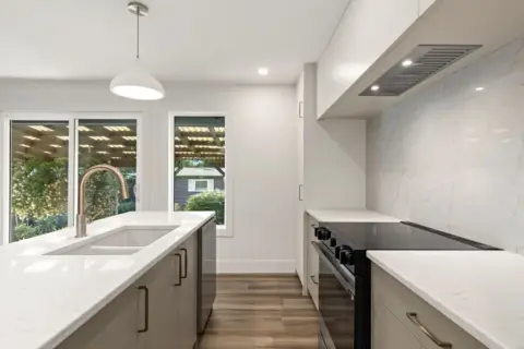 Sleek Japandi style kitchen with modern custom cabinetry after renovation