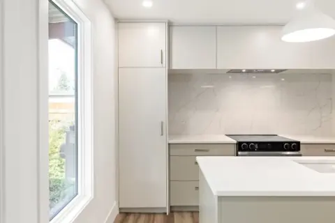 Sleek Japandi style kitchen with modern custom cabinetry after renovation