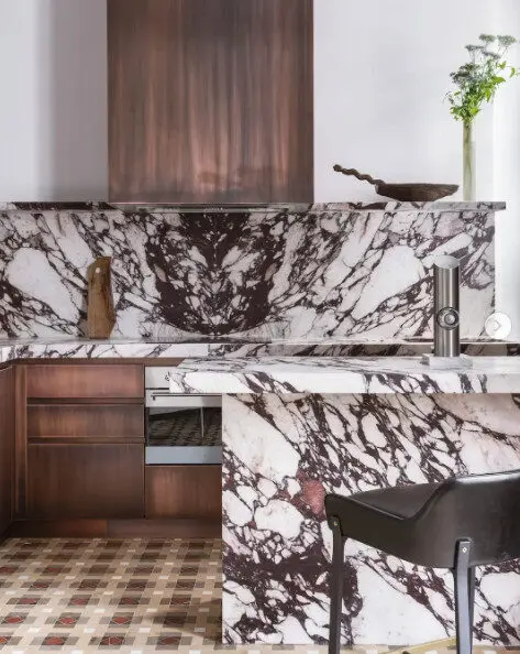 Kitchen with dramatic marble countertop and backsplash