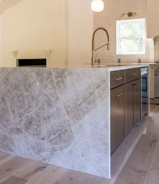 Kitchen island with quartzite waterfall countertop