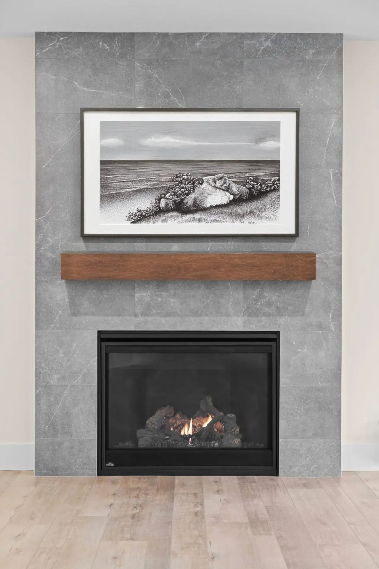 Tiled fireplace with mantel in renovated Calgary home